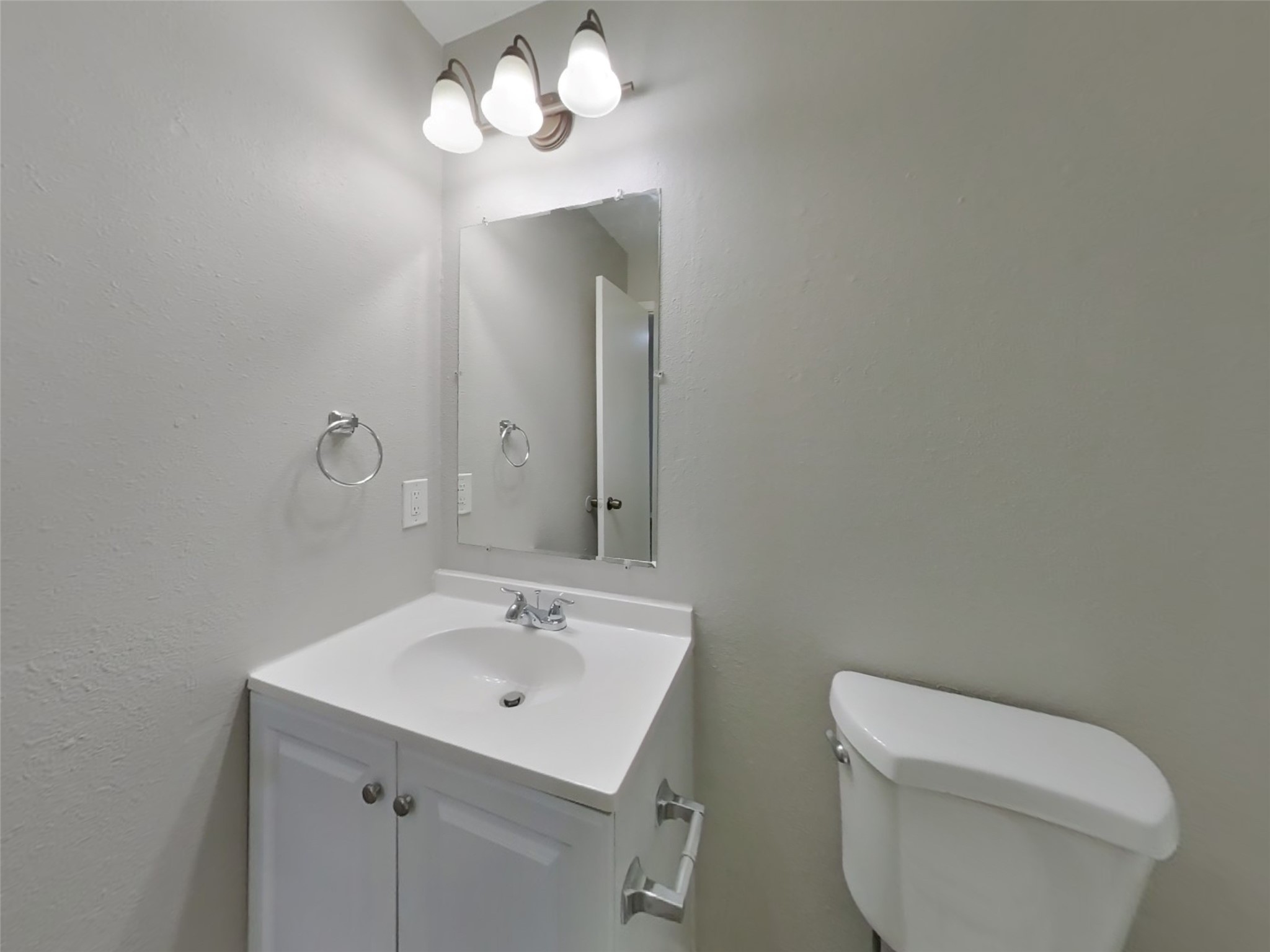 15019 Easingwold Drive Channelview, TX 77530 - Photo 15 of 17 a bathroom with a toilet sink and mirror