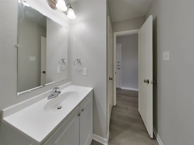 a spacious bathroom with a sink and mirror