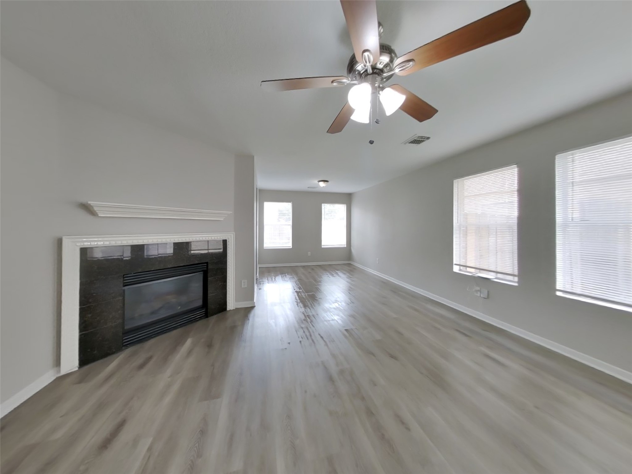15019 Easingwold Drive Channelview, TX 77530 - Photo 3 of 17 a view of an empty room with wooden floor and a window