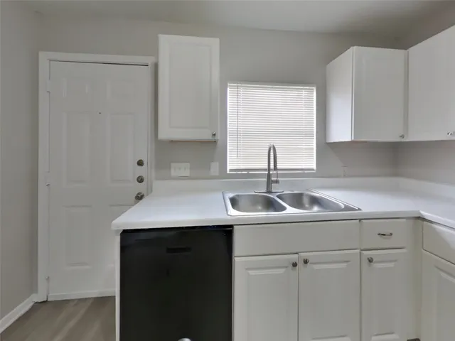 a kitchen with a sink and cabinets