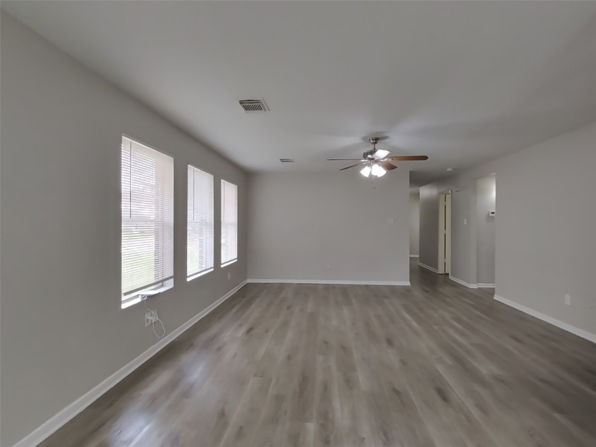 15019 Easingwold Drive Channelview, TX 77530 - Photo 7 of 17 a view of empty room with wooden floor and fan