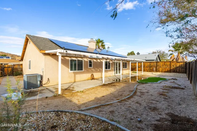 a aerial view of a house with a backyard