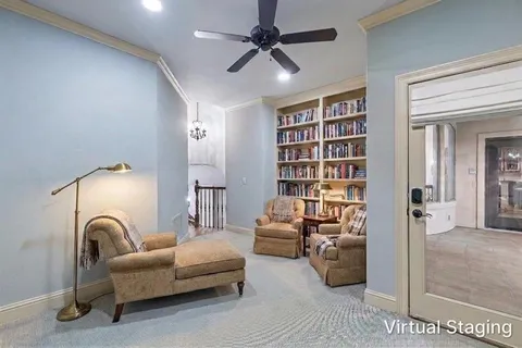 a living room with furniture and a book shelf