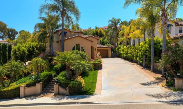 a view of a house with a yard and potted plants