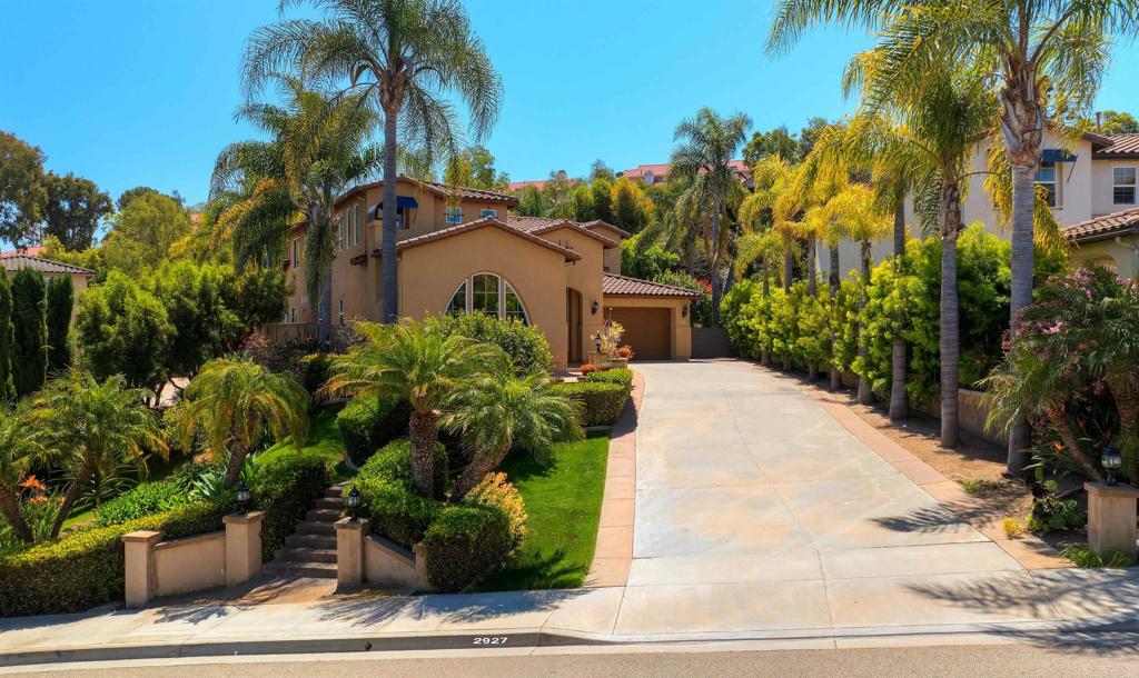 a view of a house with a yard and potted plants