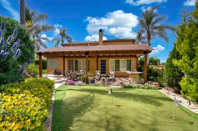 a front view of house with swimming pool and furniture