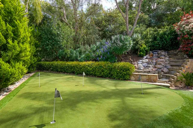 a swimming pool with some trees in the background