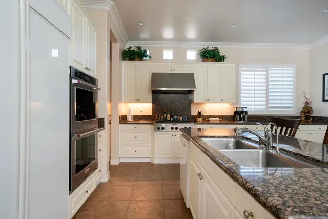a kitchen with a sink stove and microwave