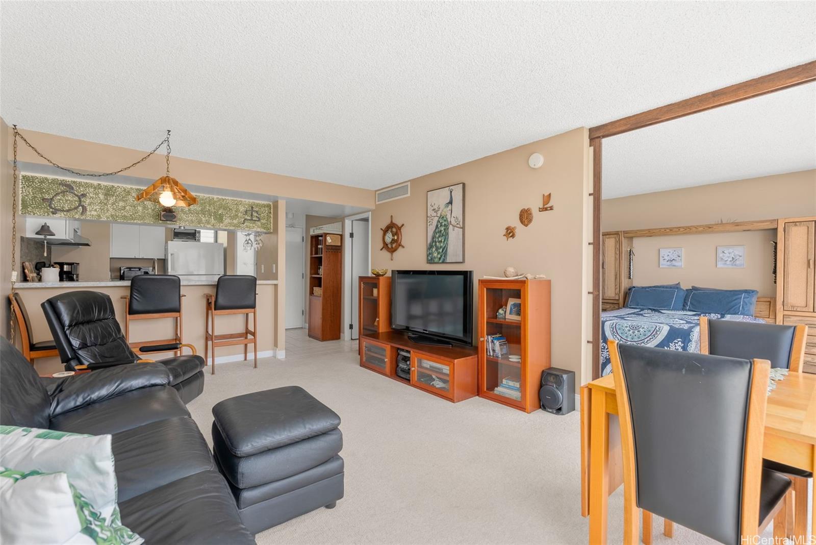 84-680 Kili Drive, Unit C1210 Waianae, HI 96792 - Photo 11 of 24 a living room with furniture and a flat screen tv