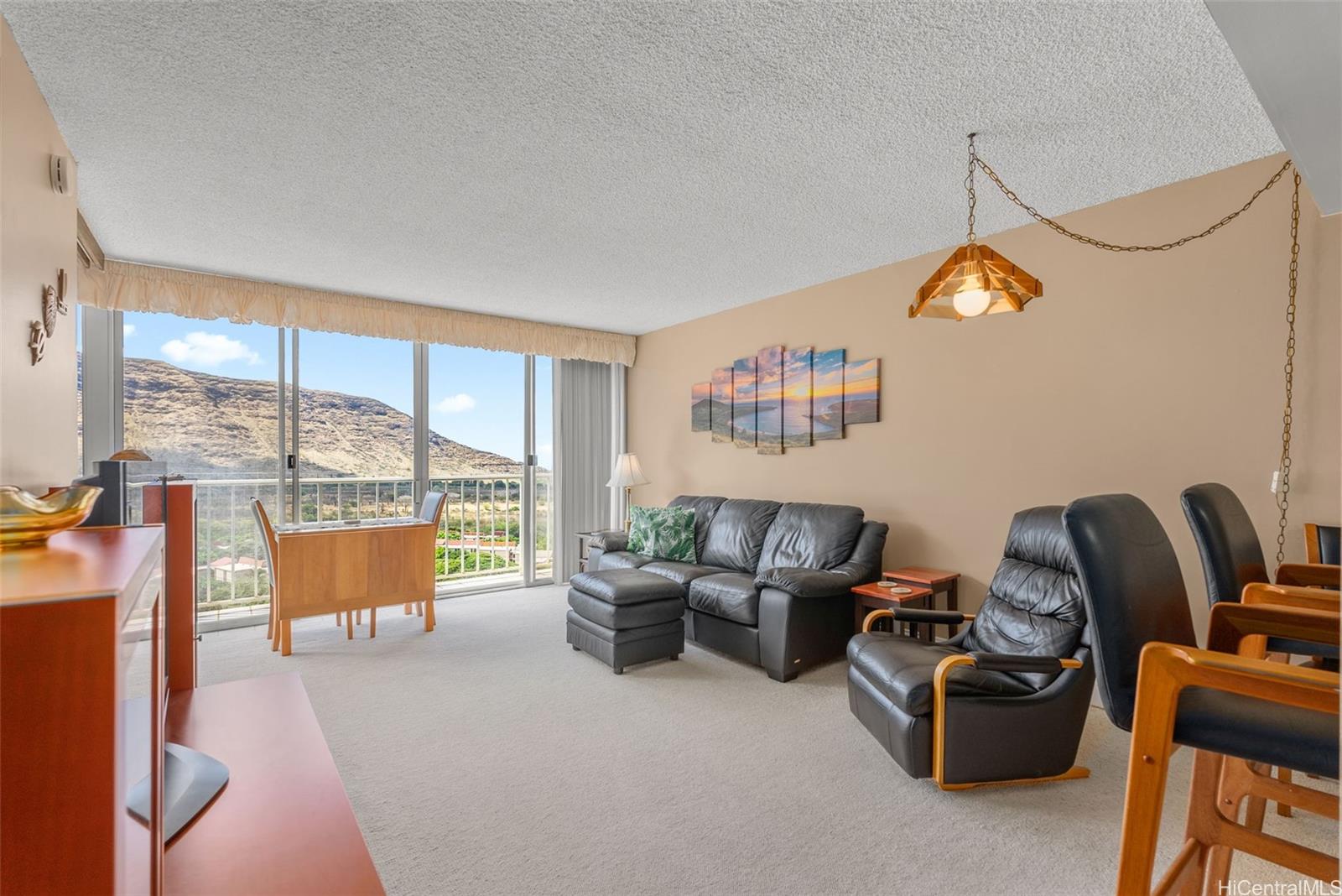 84-680 Kili Drive, Unit C1210 Waianae, HI 96792 - Photo 12 of 24 a living room with furniture and a floor to ceiling window