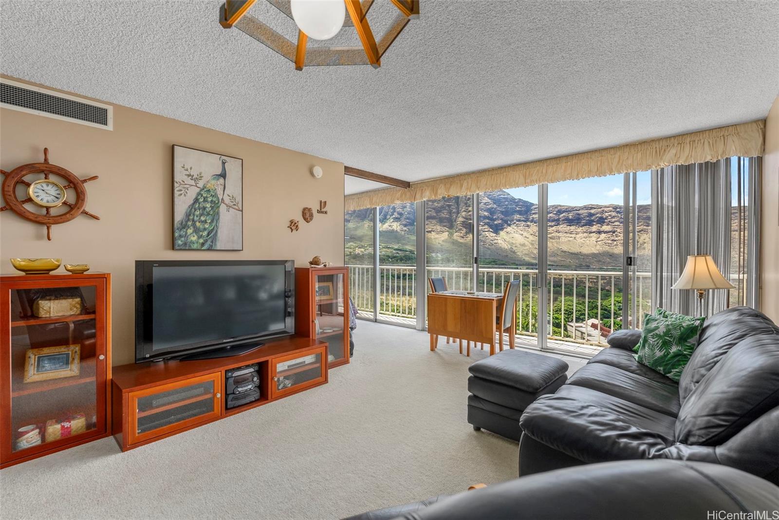84-680 Kili Drive, Unit C1210 Waianae, HI 96792 - Photo 13 of 24 a living room with furniture and a flat screen tv