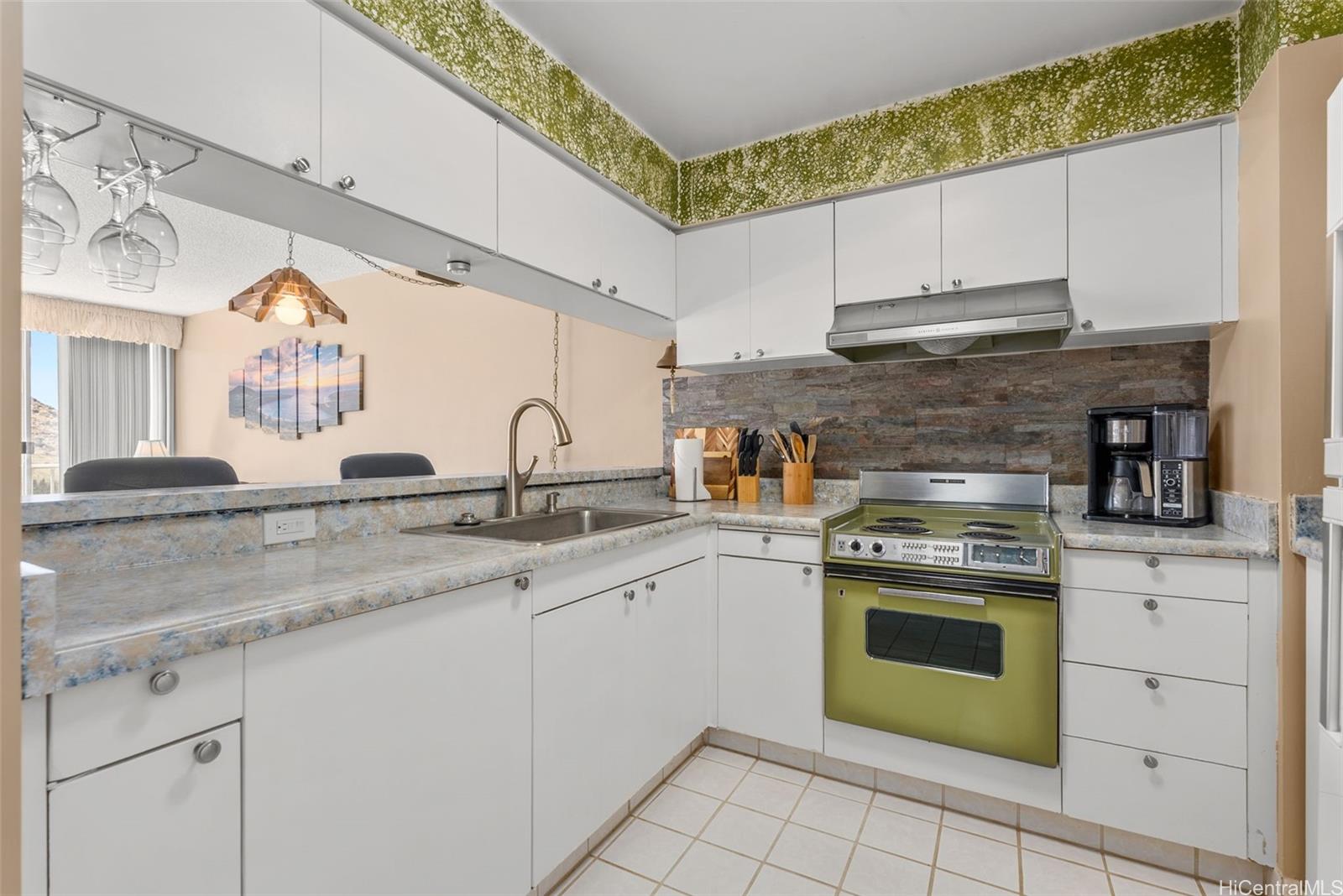 84-680 Kili Drive, Unit C1210 Waianae, HI 96792 - Photo 16 of 24 a kitchen with stainless steel appliances granite countertop a sink and cabinets