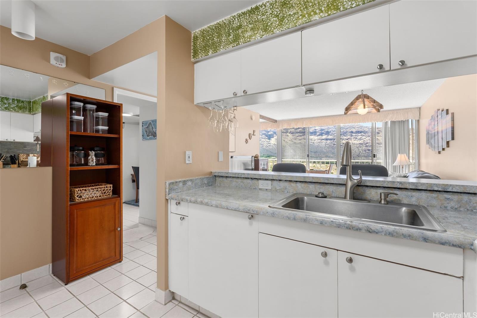 84-680 Kili Drive, Unit C1210 Waianae, HI 96792 - Photo 17 of 24 a kitchen with stainless steel appliances granite countertop a sink and a cabinets