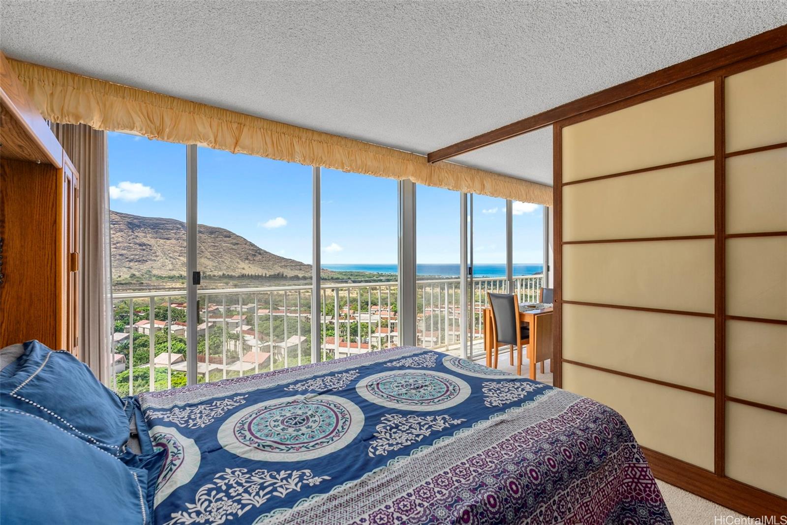 84-680 Kili Drive, Unit C1210 Waianae, HI 96792 - Photo 8 of 24 a bed sitting in a bedroom next to a window