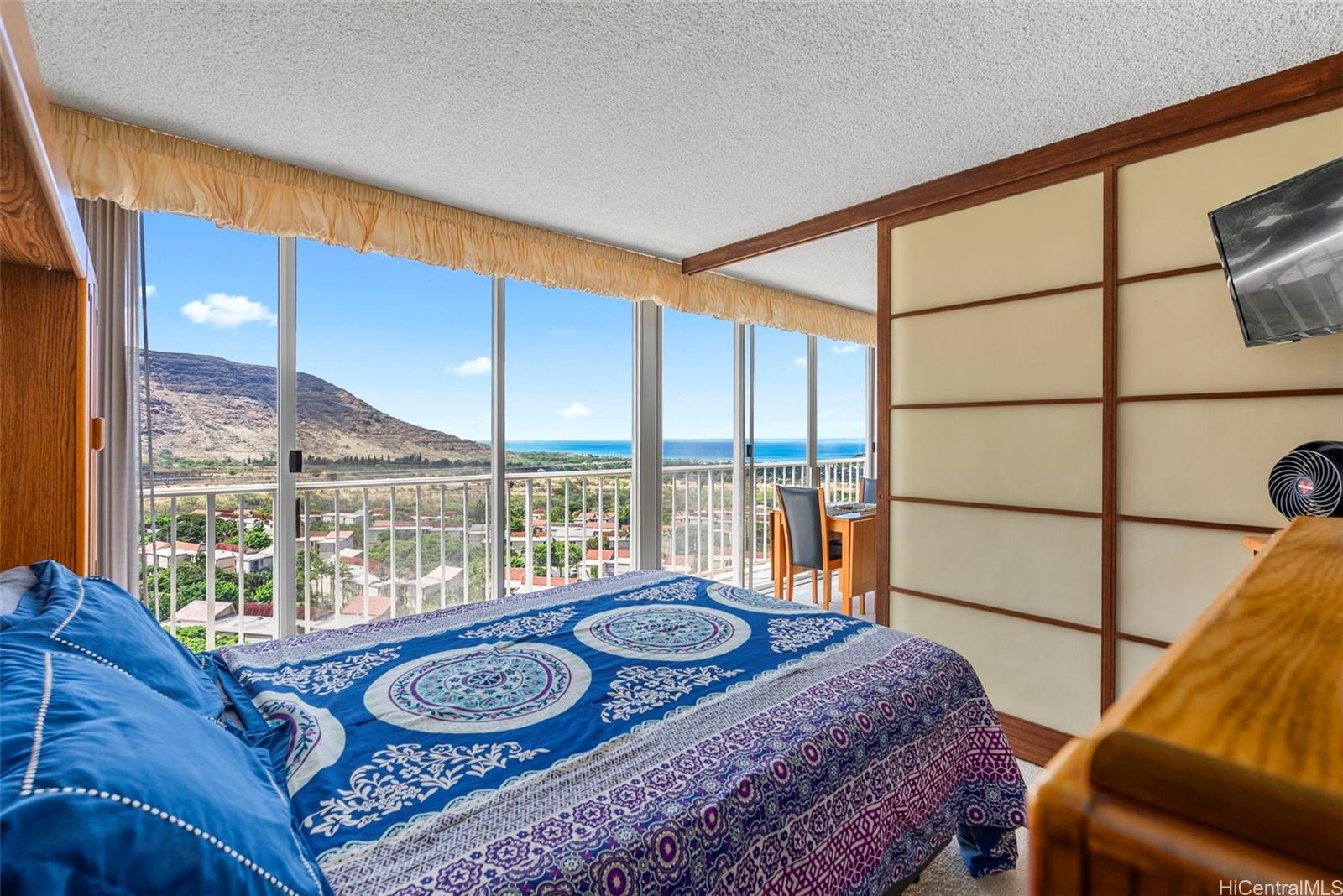 84-680 Kili Drive, Unit C1210 Waianae, HI 96792 - Photo 9 of 24 a living room with a couch and a floor to ceiling window