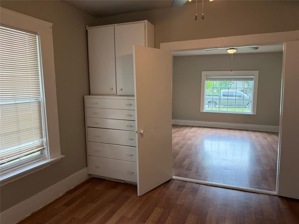 801 Wayne Street Dallas, TX 75223 - Photo 5 of 15 an empty room with wooden floor cabinet and windows