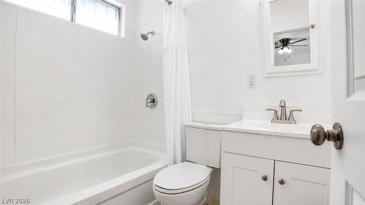2870 South Sandhill Road Las Vegas, NV 89121 - Photo 54 of 64 A pristine bath features a window above the shower, a well-appointed vanity, and a clean commode.
