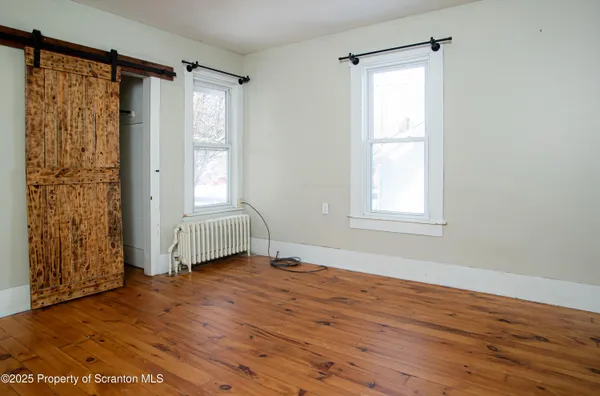 a view of an empty room and a window