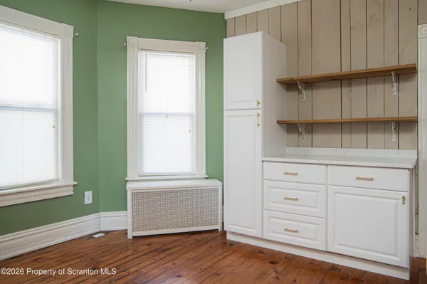 a view of a kitchen with wooden cabinets and a window