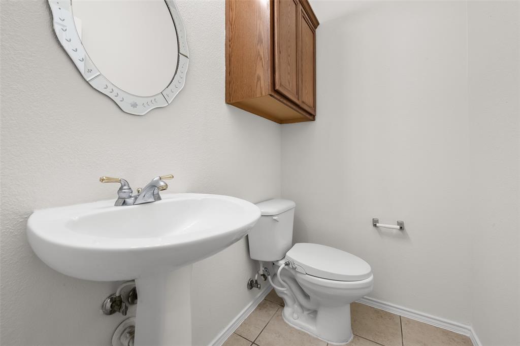 8524 Heather Ridge Drive Plano, TX 75024 - Photo 13 of 27 a bathroom with a sink a toilet and a mirror