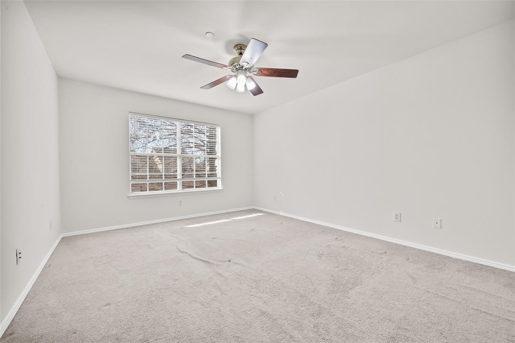 8524 Heather Ridge Drive Plano, TX 75024 - Photo 14 of 27 an empty room with windows and fan