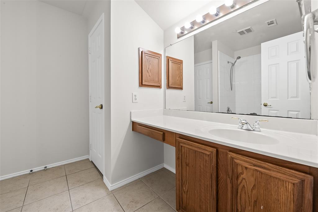 8524 Heather Ridge Drive Plano, TX 75024 - Photo 16 of 27 a bathroom with a sink and a mirror