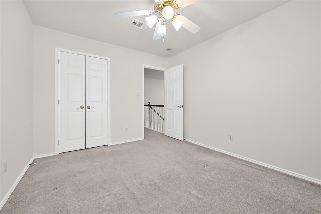 8524 Heather Ridge Drive Plano, TX 75024 - Photo 19 of 27 an empty room with chandelier fan and closet area