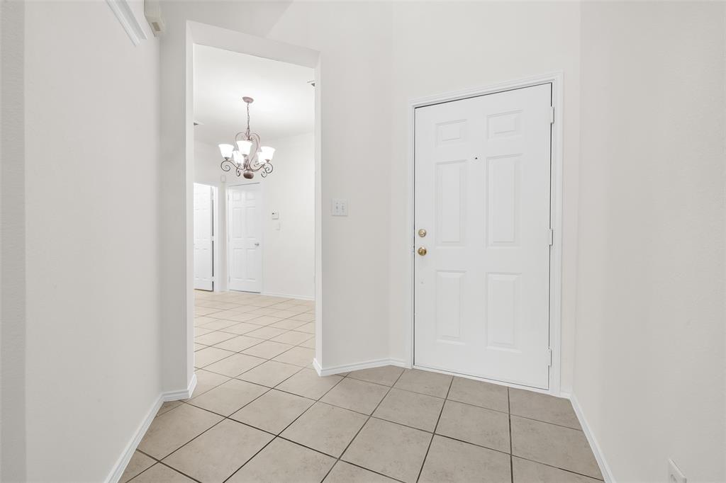 8524 Heather Ridge Drive Plano, TX 75024 - Photo 3 of 27 an empty room with chandelier