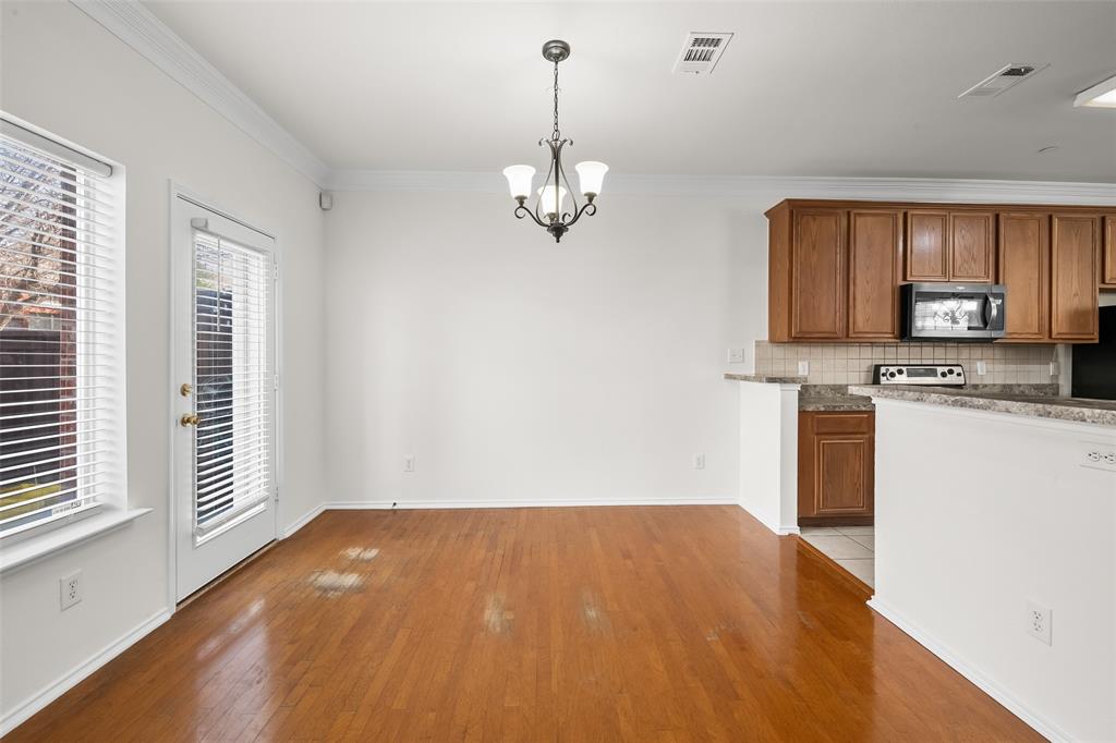 8524 Heather Ridge Drive Plano, TX 75024 - Photo 9 of 27 a view of a kitchen with a stove cabinets and a wooden floor