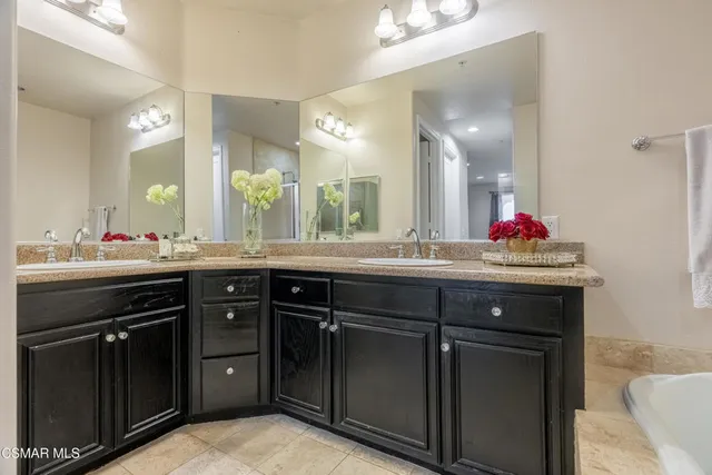 a bathroom with a double vanity sink and a mirror
