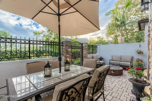 a view of a patio with couches potted plants and a potted plant