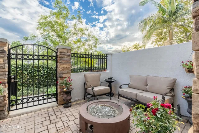a view of a patio with couches table and chairs and potted plants