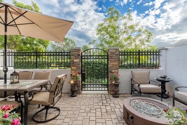 a view of a patio with iron fence