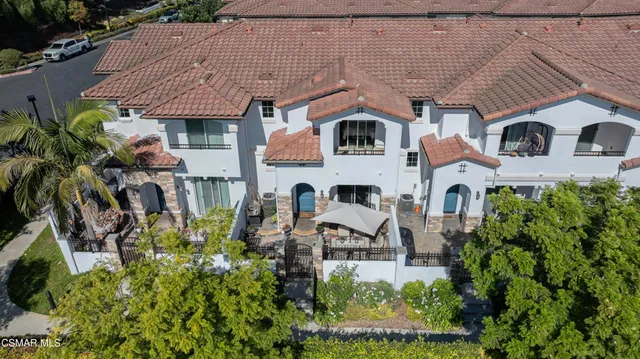 a aerial view of a house with a yard and potted plants