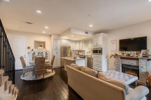 a living room with furniture fireplace and flat screen tv