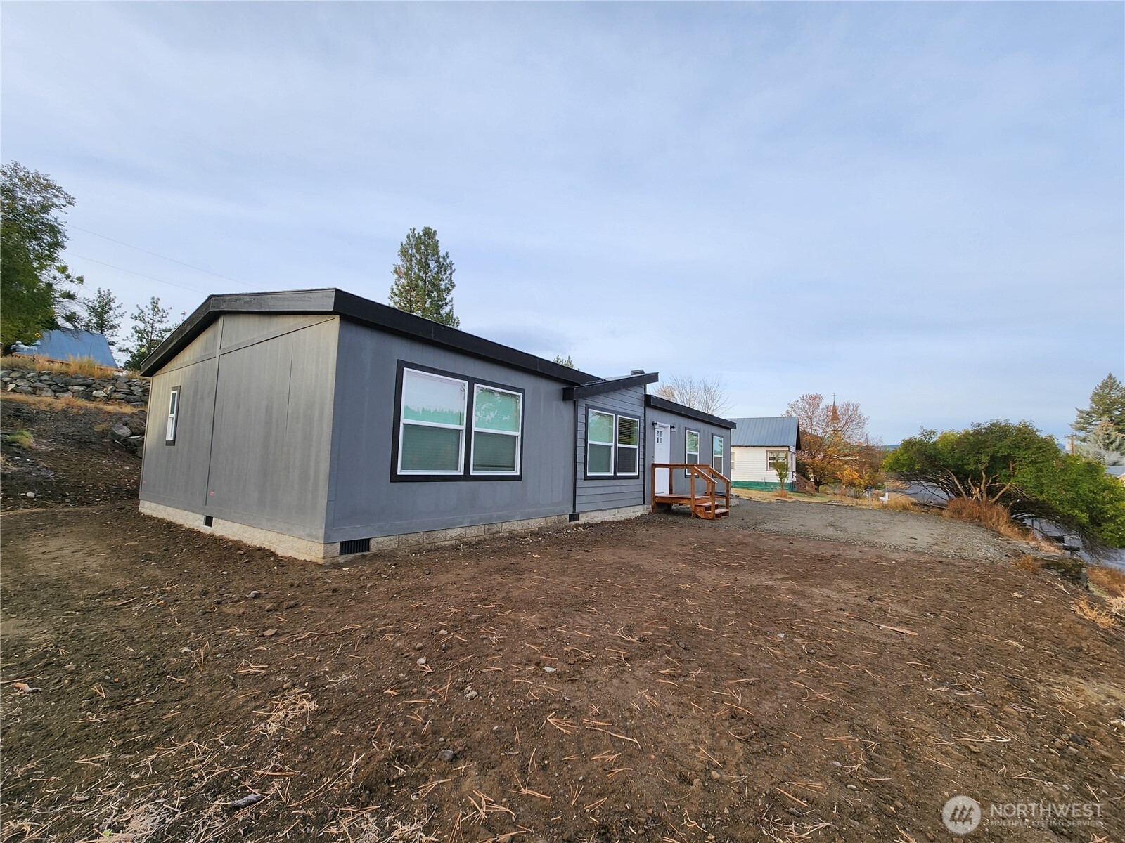 720 South Jefferson Street Republic, WA 99166 - Photo 20 of 27 a big house with a big yard and large trees