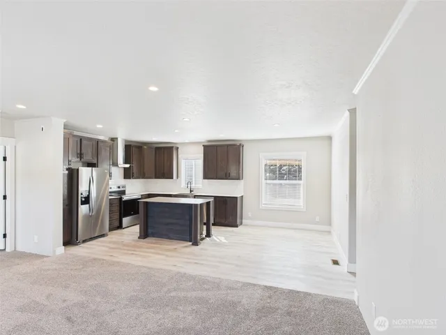 a view of a living room kitchen with furniture and flat screen tv