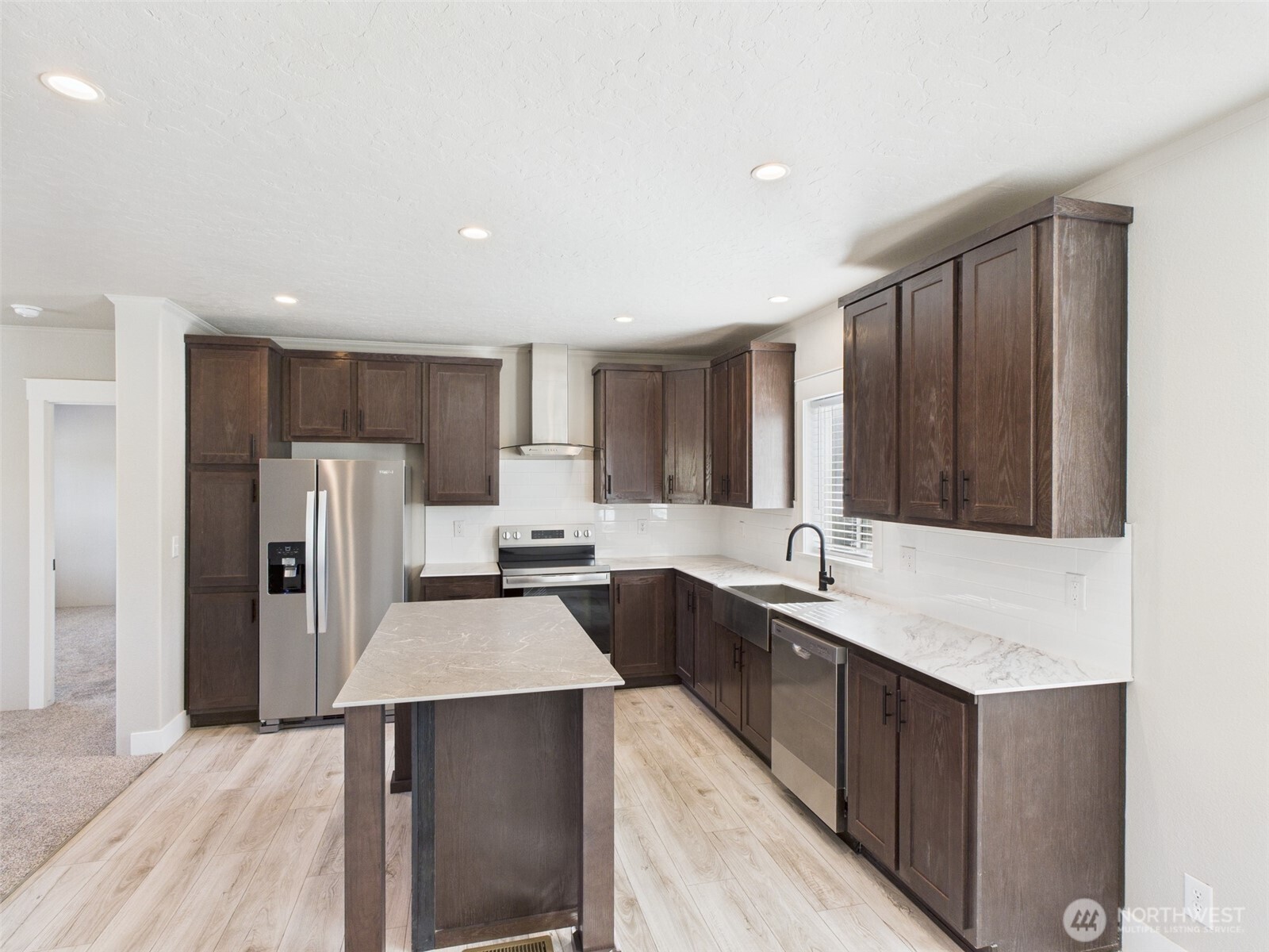 720 South Jefferson Street Republic, WA 99166 - Photo 8 of 27 a large kitchen with kitchen island a sink stainless steel appliances and cabinets