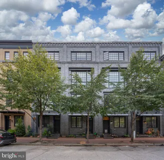 a large building with a tree in front of it