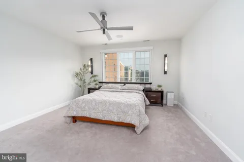 a spacious bedroom with a bed and a chandelier