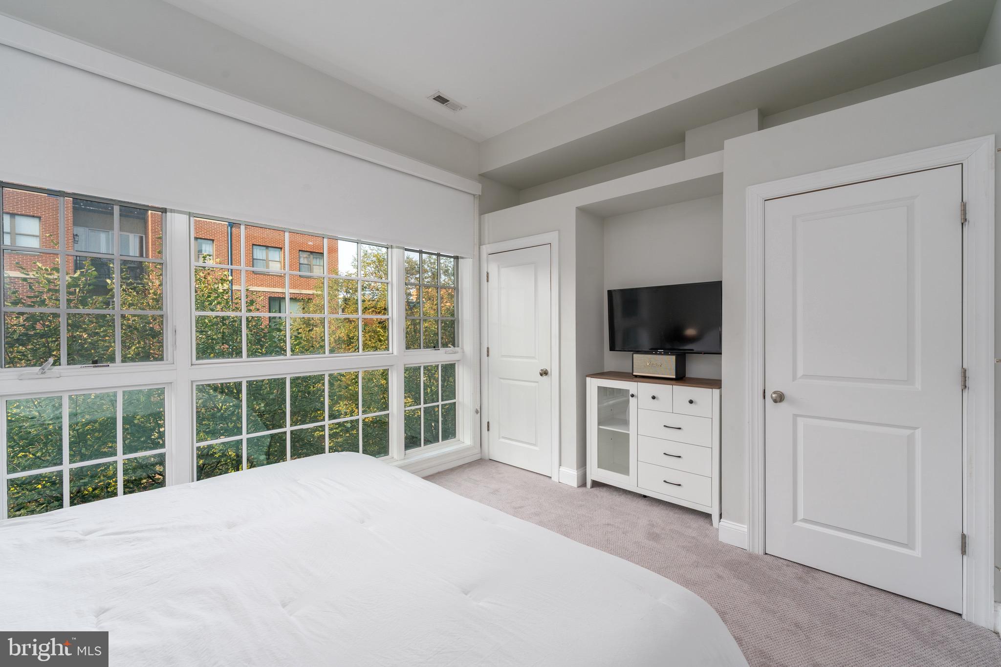 1735 Aliceanna Street Baltimore, MD 21231 - Photo 17 of 48 a view of a bedroom with window and flat screen tv