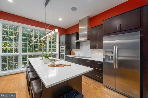 a kitchen with a table chairs and refrigerator
