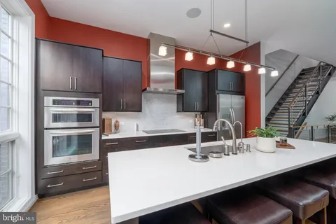 a kitchen with kitchen island a sink appliances and cabinets