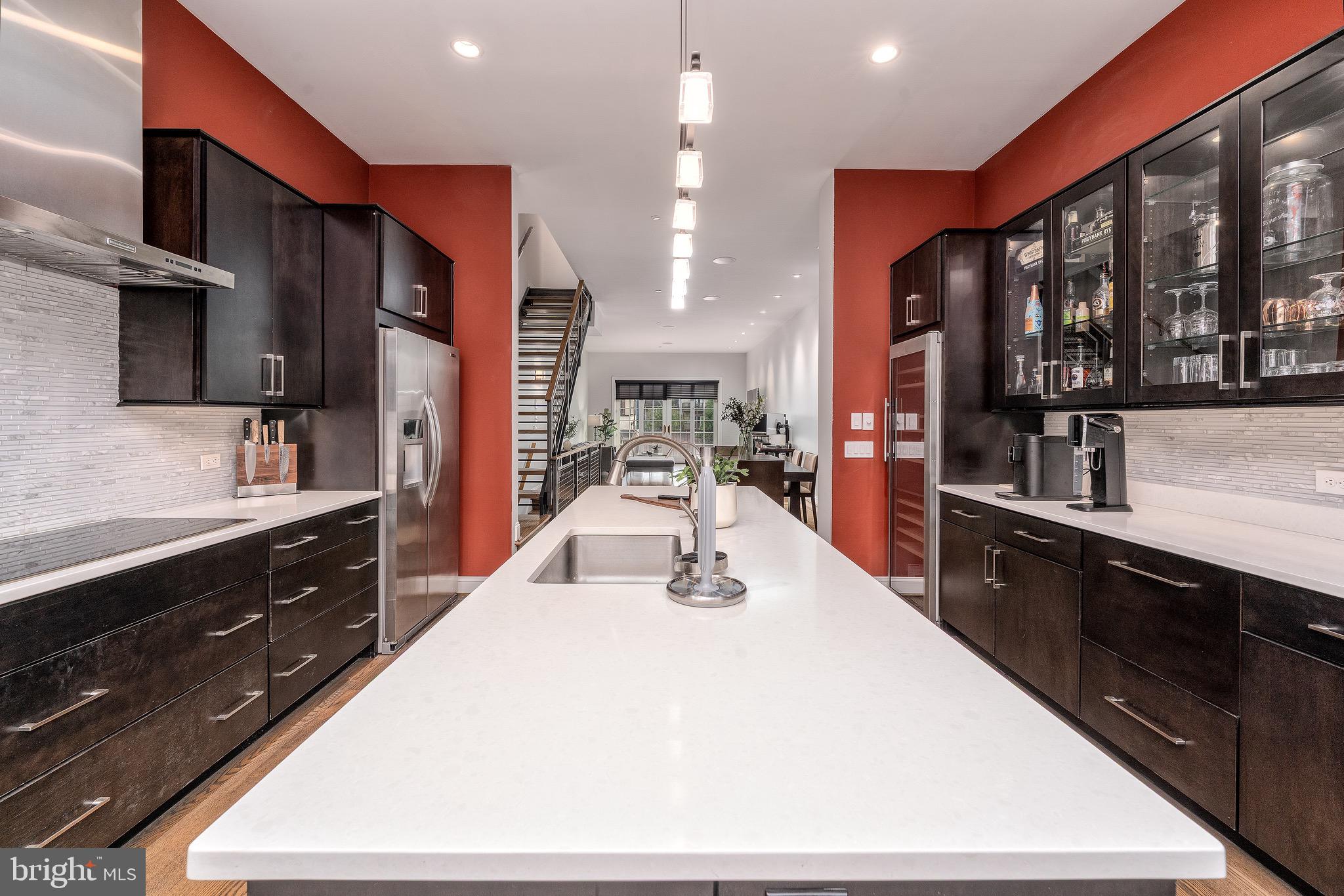 1735 Aliceanna Street Baltimore, MD 21231 - Photo 7 of 48 a large kitchen with stainless steel appliances a large counter top oven and cabinets