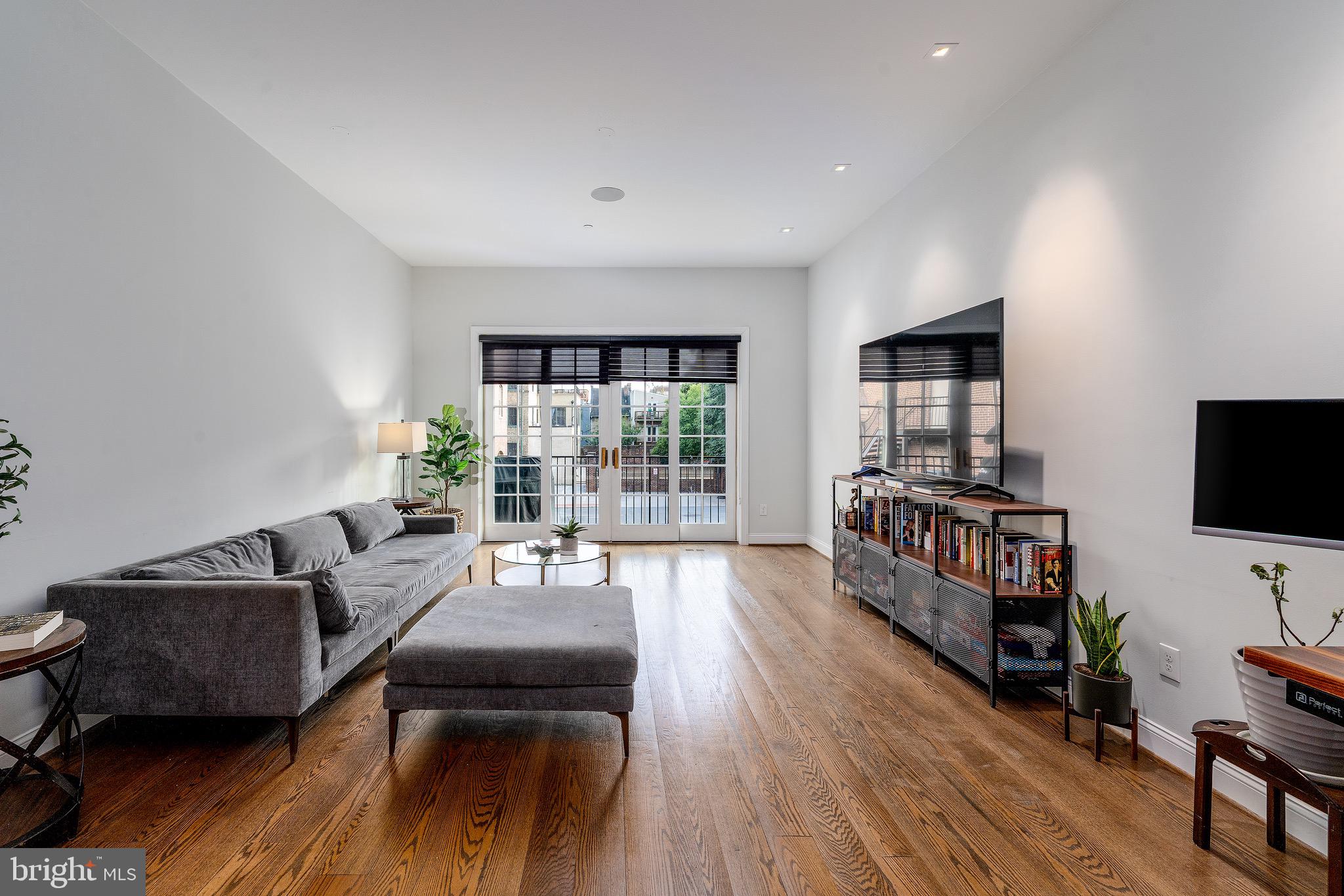 1735 Aliceanna Street Baltimore, MD 21231 - Photo 8 of 48 a living room with furniture and a flat screen tv