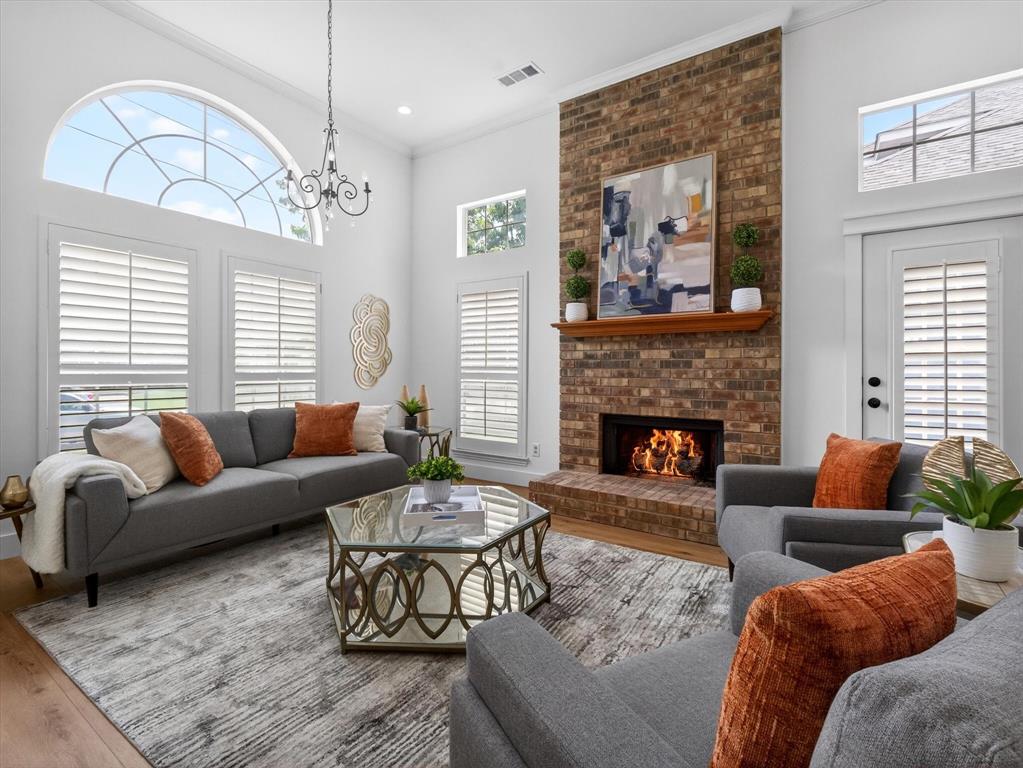 4345 Timberglen Road Dallas, TX 75287 - Photo 5 of 26 a living room with furniture a chandelier and a fireplace