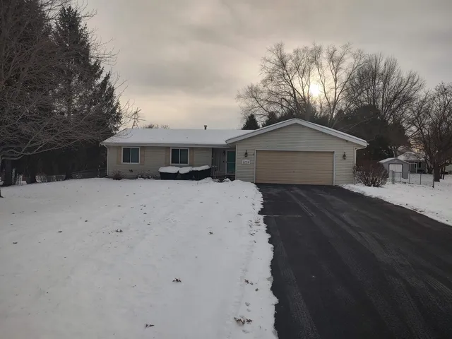 a white house with a large tree in front of it