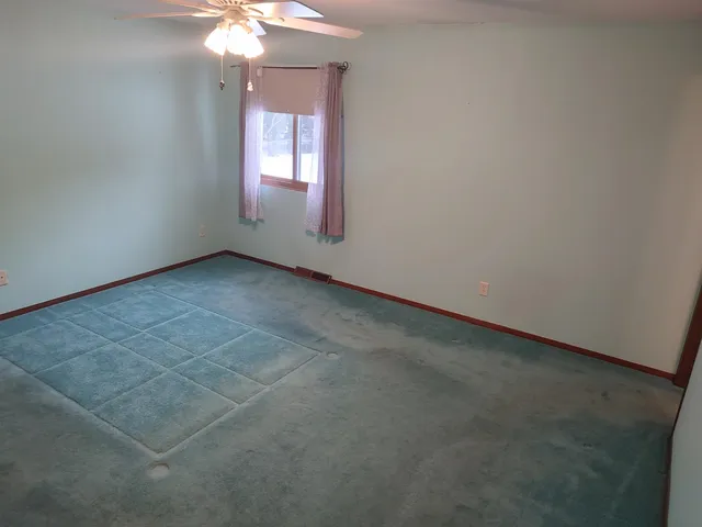 a white toilet sitting next to a shower curtain