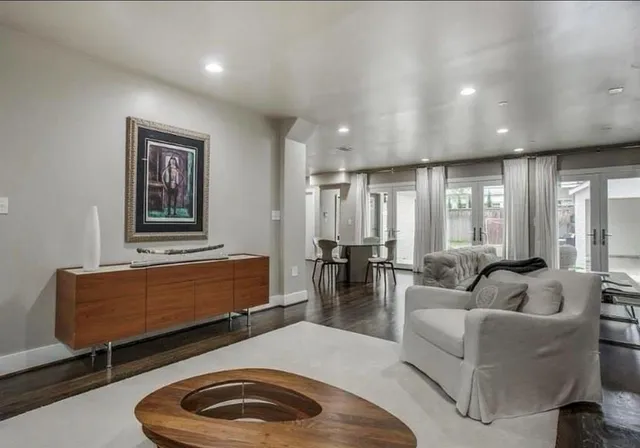 a living room with furniture and large window