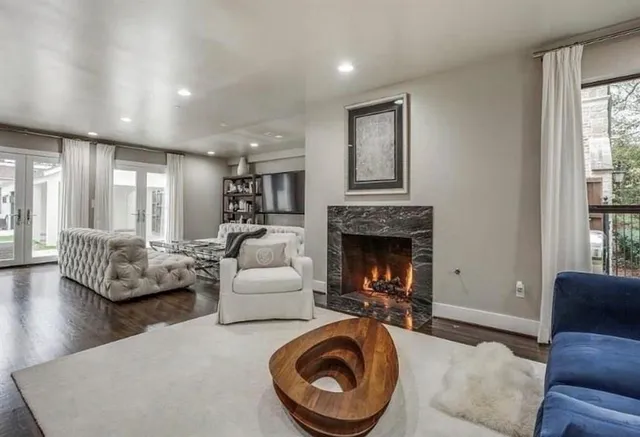 a living room with furniture and a fireplace